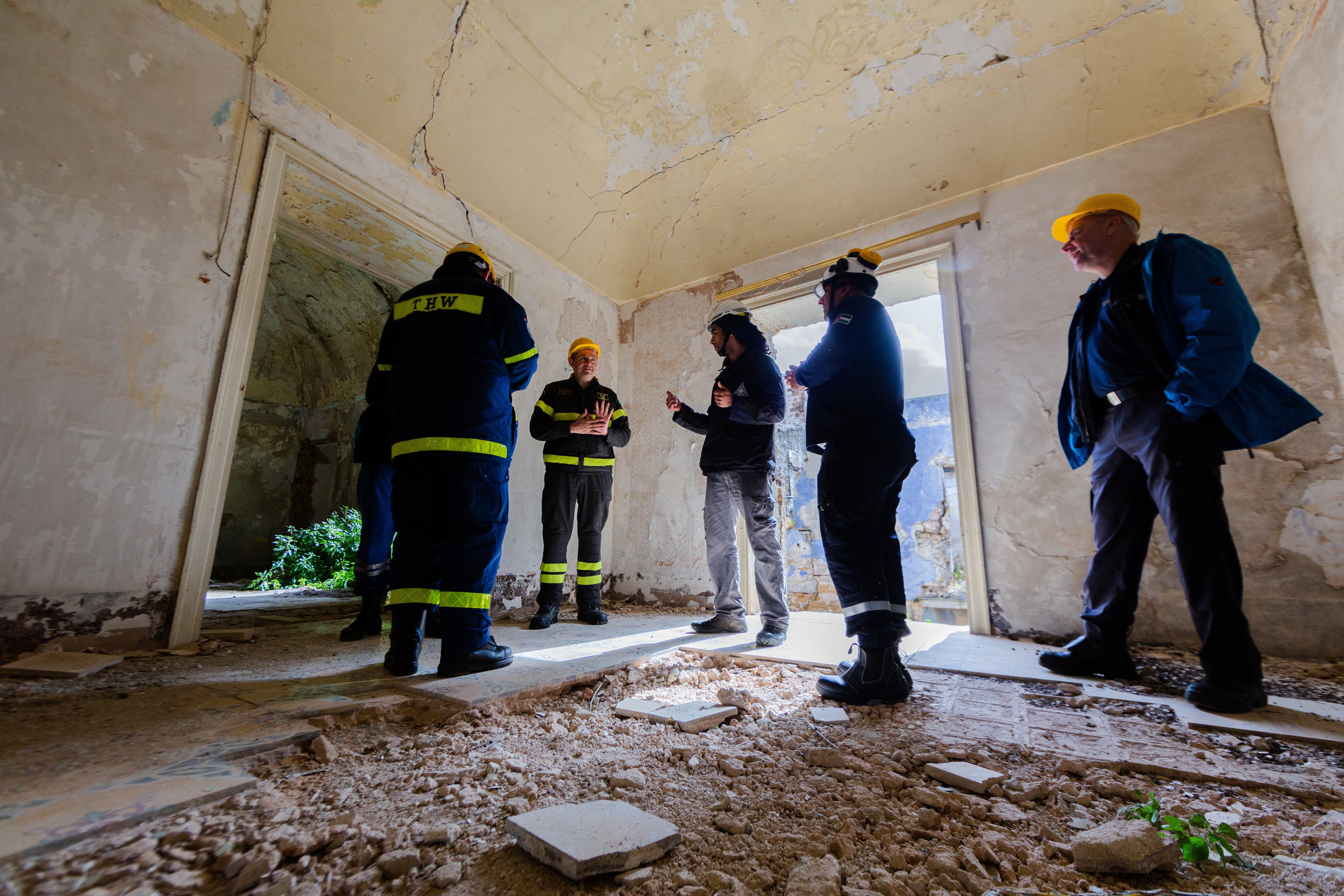 Engineers conducting a structural inspection inside a damaged building